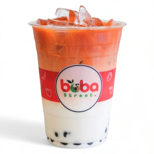 Boba Street's Thai Iced Tea with boba and ice in a clear plastic cup.