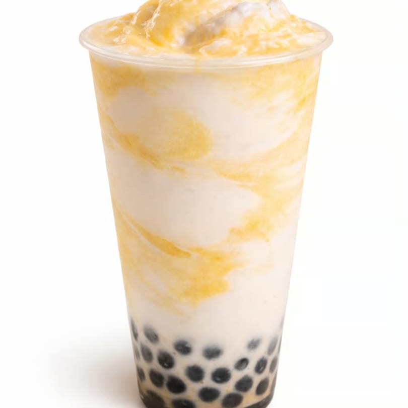 A tall plastic cup of mango boba tea with white and yellow swirls and black tapioca pearls.