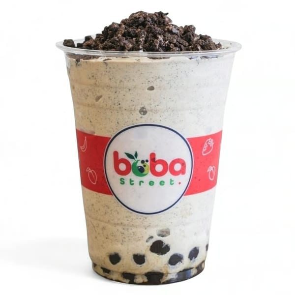 Boba Street's cookies and cream boba drink, topped with crushed cookies, against a white background.